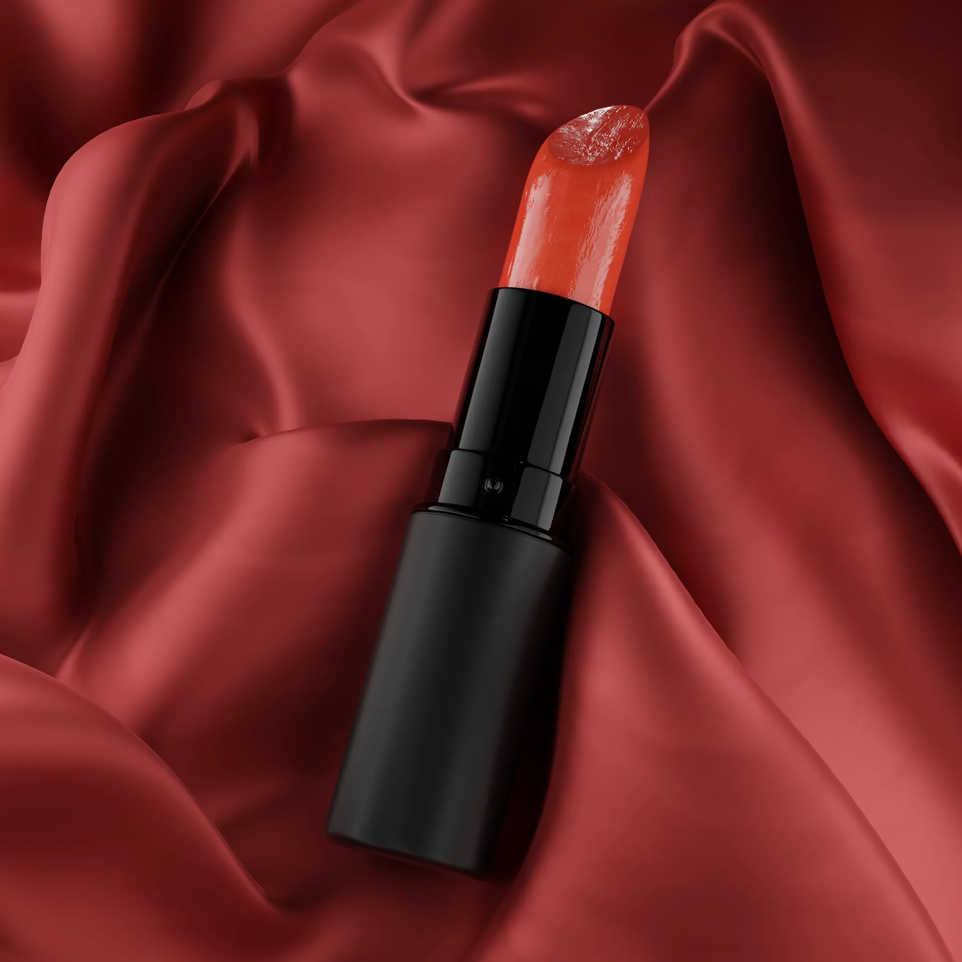 Labial rojo recostado sobre seda roja simulada